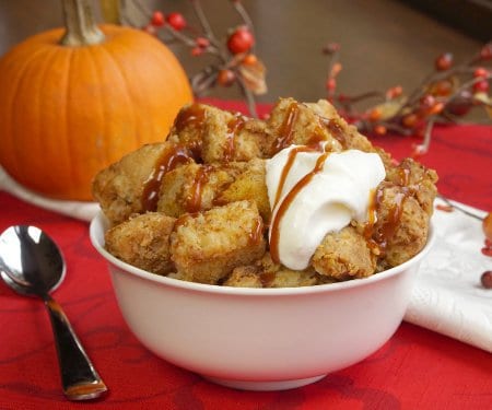 Just as good as warm pumpkin pie, this crock pot pumpkin bread pudding recipe is healthy enough for a fall breakfast, but it's enough of a treat, that it makes a wonderful dessert too! | www.CuriousCuisiniere.com