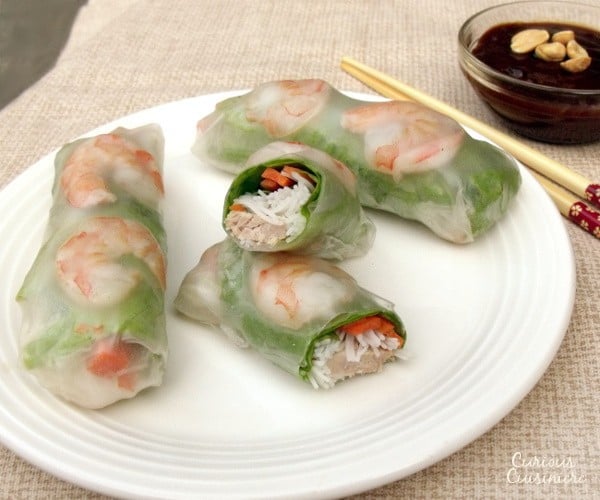 猪肉,虾,生菜,新鲜的草药,胡萝卜和米粉包裹在米纸中,使春卷健康的午餐或小吃。包括有关如何缠绕和滚动弹簧卷的详细说明。|m.jamahire.com.