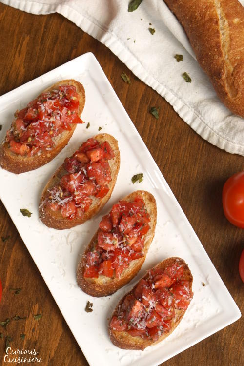 这道经典的番茄罗勒意式烤面包的特色是完美的，明亮的香草番茄配上脆蒜吐司。| www.CuriousCuisiniere.com